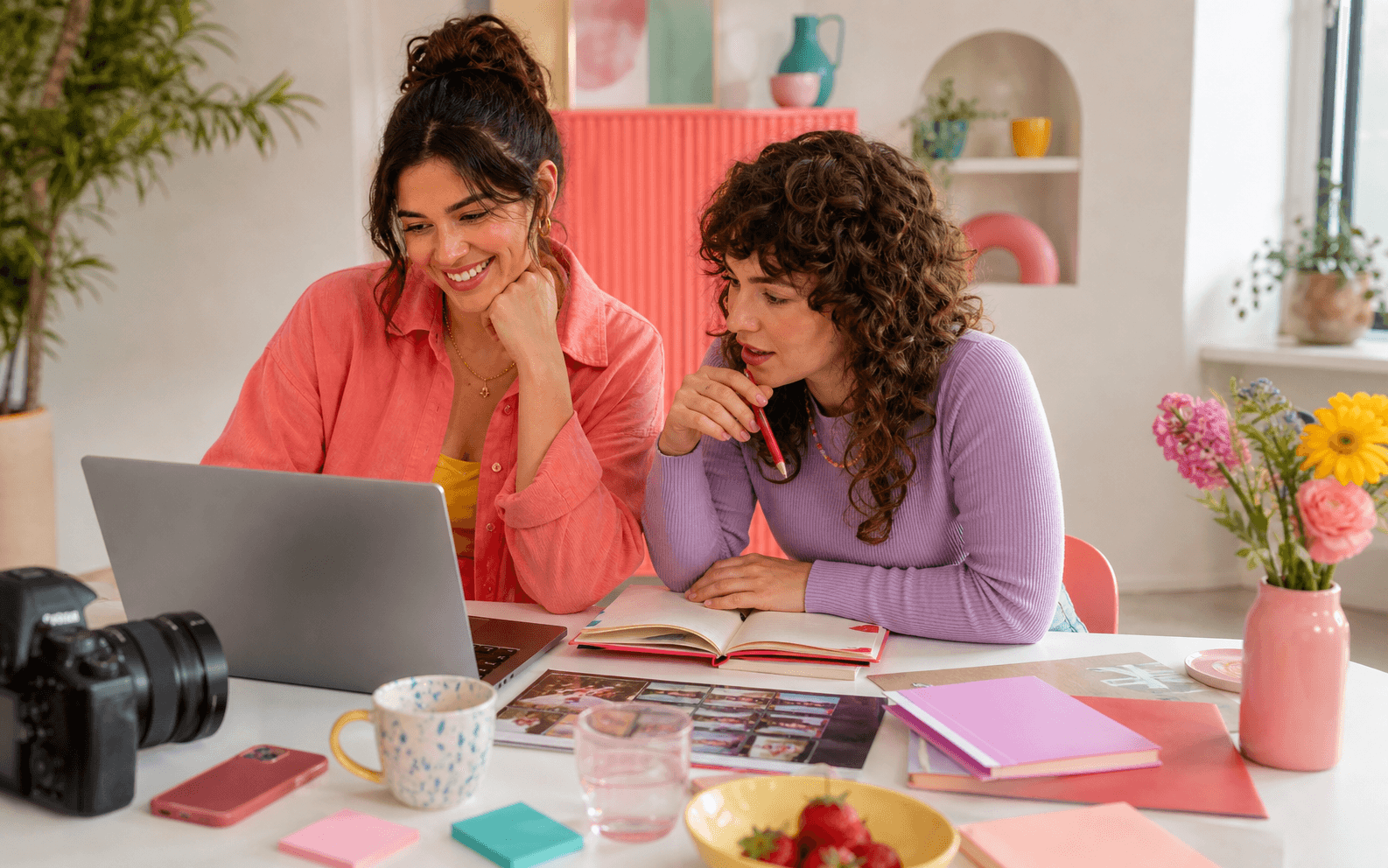 Adult creator planning content at a colorful desk